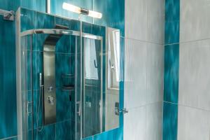 a bathroom with a glass shower with a mirror at Angelikis Maisonette in Kastoria +78 photos