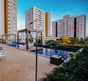 a swimming pool in a city with tall buildings at CRCN - Evian Thermas Residence in Caldas Novas