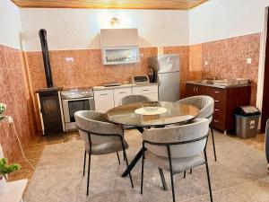 a kitchen with a table and chairs in a room at The Mountain's Embrace Villa in Gluhi Do +7 photos