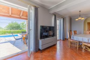 a bedroom with a bed and a view of a patio at Villa Andretti in Gračišće