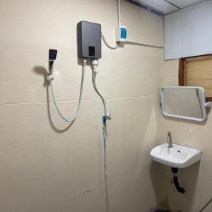 a bathroom with a sink and a tv on the wall at Hidden Valley Pai in Pai