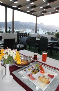 a table with two plates of food on it at Grand Center Boutique Hotel in Kyrenia