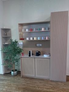 a kitchen with a shelf with pots and pans at فيلا الريف in Kusāt