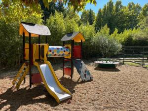 a playground with two slides and a play structure at Camping Pegomas in Saint-Rémy-de-Provence +33 photos