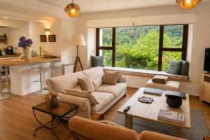a living room with a couch and a table at La Casina de San Pedro Ribadesella in Ribadesella