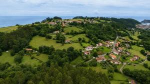 an aerial view of a small village on a hill at La Casina de San Pedro Ribadesella in Ribadesella
