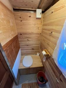a small wooden bathroom with a toilet in it at roulotte les sabots d Helene in Cruzilles-lès-Mépillat