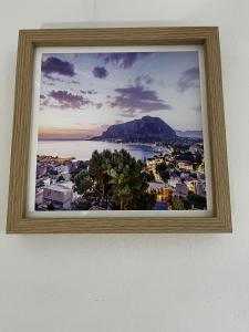 a framed picture of a city and the water at Pellegrino House in Palermo