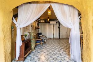 an entrance to a room with a white curtain at OXY Cave Homestay Mũi Né in Mui Ne