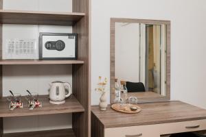 a room with a desk with a microwave and a mirror at Babin bed&breakfast in Pirovac