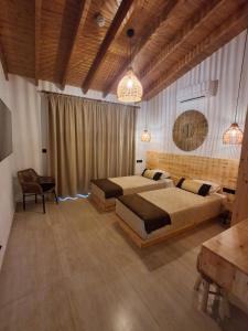 a large bedroom with two beds and a table at Simos Magic Beach Hotel Apts in Ayia Napa +129 photos