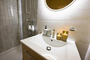 a bathroom with a sink and a shower and a mirror at Spa Thermal, Design, Terrasse in Saillon