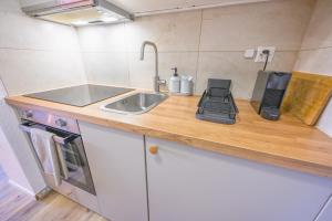 a kitchen counter with a sink and a phone on it at Spa Thermal, Design, Terrasse in Saillon +54 photos