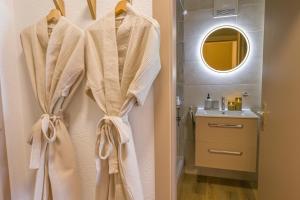 a bathroom with a robe hanging on a wall at Spa Thermal, Design, Terrasse in Saillon