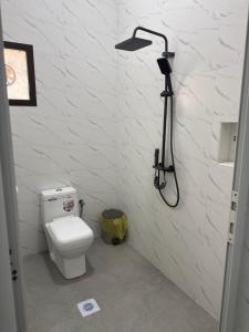 a bathroom with a toilet and a shower at فيلا الريف in Kusāt +22 photos