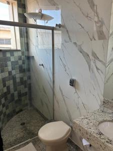 a bathroom with a toilet and a sink at Diplomata Hotel in Sertãozinho +26 photos