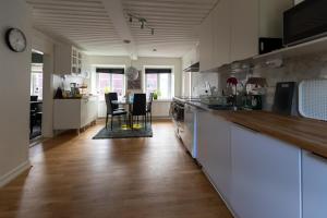 a kitchen with a counter and a table and chairs at Nordic Lodges in Malmö