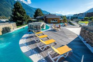 a swimming pool with lounge chairs and a water slide at Spa Thermal, Design, Terrasse in Saillon