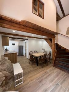 a kitchen and dining room with a table and chairs at Pr'Tončih in Podgorje