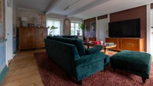 a living room with a couch and a tv at Nordic Lodges in Malmö