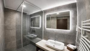 a bathroom with a sink and a mirror at Apartments and Rooms Villa Majestic in Bihać +221 photos
