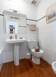 a white bathroom with a sink and a toilet at Between sea and Altafulla castle in Altafulla +46 photos