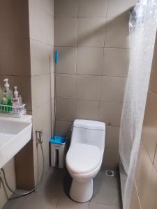 a small bathroom with a toilet and a sink at Staycationbabe in Manila