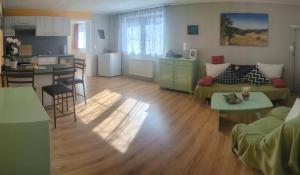 a living room with a couch and a table at Ferienwohnung Am Apelsberg in Neuhaus am Rennweg