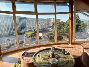 a large room with a table and large windows at Lambada Penthouse in Bugojno