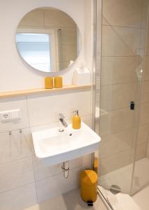 a bathroom with a sink and a mirror at Hotel Seehof Norderney OHG in Norderney