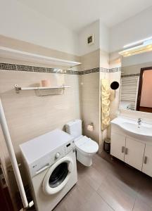 a bathroom with a washing machine and a sink at Apartament Centru Plaja Modern in Constanţa +24 photos