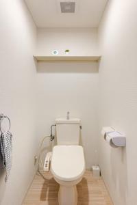 a bathroom with a white toilet in a room at Cozy Japandi 3LDK in Namba for Groups in Osaka