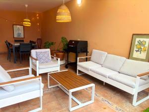 a living room with white couches and a table at Villa Casa Papaya - All Year Heated Pool in La Orotava