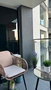 a patio with a chair and a table on a balcony at Mazury Mood kawalerka studio in Giżycko