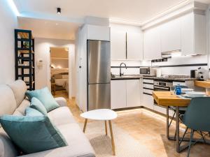 a kitchen and living room with a couch and a table at Apt. Xaramiños Galitrips in Corcubión