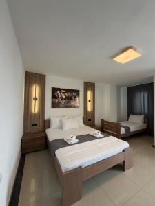 a bedroom with a large bed and a couch at Hotel Palace Struga in Struga