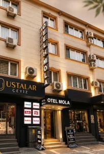 a building with a sign for a hotel at OTEL MOLA BALIKESiR in Balıkesir