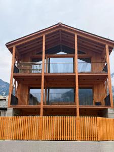 a large wooden building with a large balcony at Il Fienile di Ebbe in Bormio