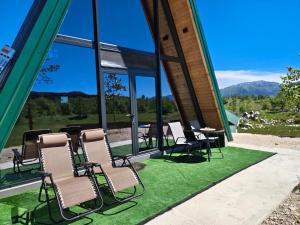 a group of chairs and tables in a building at Wolf Ridge Mountain Cabin Montenegro in Plužine