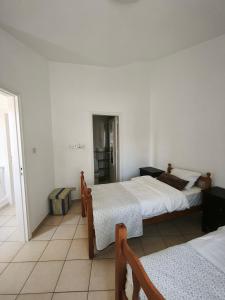 a hotel room with two beds and a window at Eden gardens in Paphos +34 photos