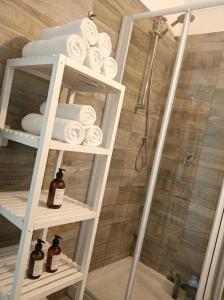 a bathroom with a rack of towels and a shower at Casa Panorama Intelvi - Como & Lugano Lakes in Laino