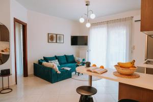 a living room with a blue couch and a table at Tina's Resident in Igoumenitsa
