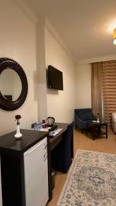 a living room with a couch and a mirror at Saif Al Majd Hotel in Mecca
