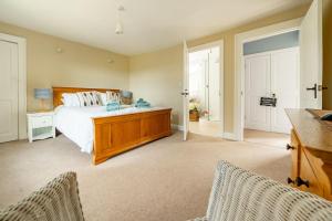 a bedroom with a bed and two chairs at Laylands in Wells next the Sea