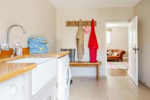 a kitchen with a sink and a counter top at Laylands in Wells next the Sea +44 photos