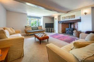 a living room with couches and a fireplace at Laylands in Wells next the Sea
