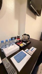 a desk with a remote control and water bottles at Saif Al Majd Hotel in Mecca