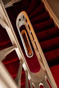 a white stair case with a cell phone on it at Boutiquehotel The Church in Arnhem +44 photos