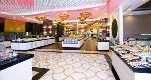a buffet line in a restaurant with food on display at LRS Hotels Port River Hotel & Spa - Ultra All Inclusive in Side