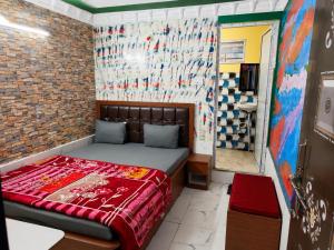 a small bedroom with a bed in a room at Hotel Alankar Lodge Kharagpur in Kharagpur